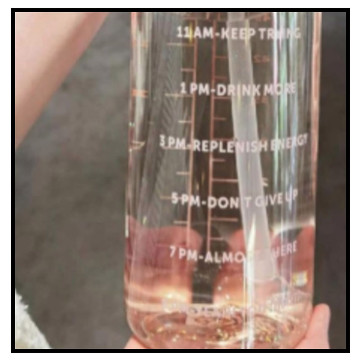 💧 Transparent Water Bottle – Clear Motivational Water Bottle with White Time Markers 11AM to 7PM Filled with Pink Water Held in Hand Closeup