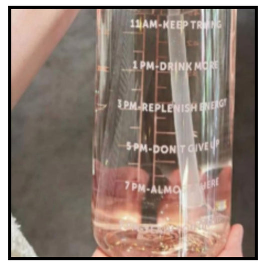 💧 Transparent Water Bottle – Clear Motivational Water Bottle with White Time Markers 11AM to 7PM Filled with Pink Water Held in Hand Closeup