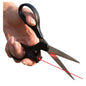 ✂️ Laser Guided Scissors – Hand Holding Black Scissors with Red Laser Pointer Attached Near Pivot Shining Red Laser Beam Across White Background for Straight Cutting