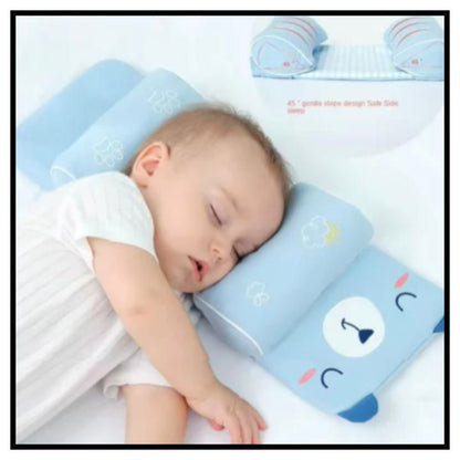 Sleeping baby lying on light blue baby head shaping support pillow with cartoon bear face design