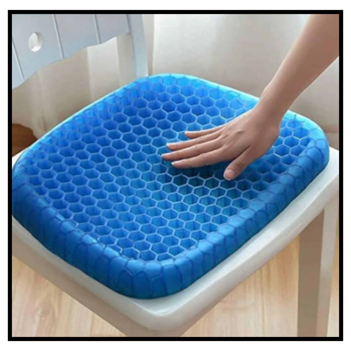 Blue honeycomb egg gel seat cushion with hand pressing to show flexible cushioning on white chair