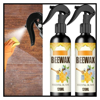 Two 120ml Beewax essential oil wax spray bottles next to hand spraying and polishing wooden floor