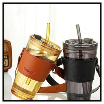 Two 450ml glass coffee mugs with reusable straws and leather sleeves in amber and gray colors on white background