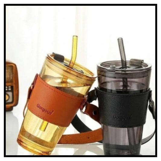 Two 450ml glass coffee mugs with reusable straws and leather sleeves in amber and gray colors on white background