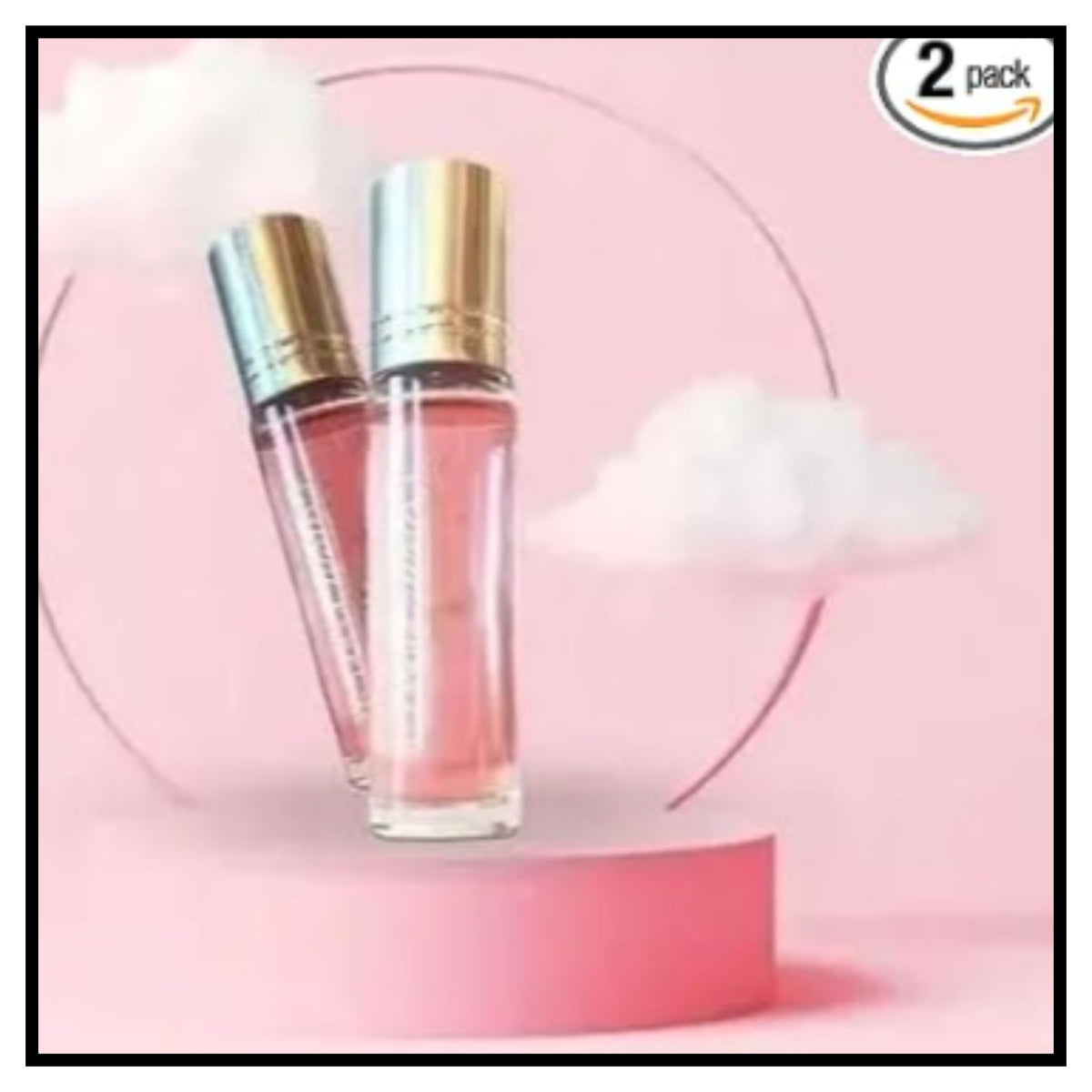 Two clear glass Pink Love perfume spray bottles with metallic gold caps filled with pink liquid displayed on pink pedestal with cloud background