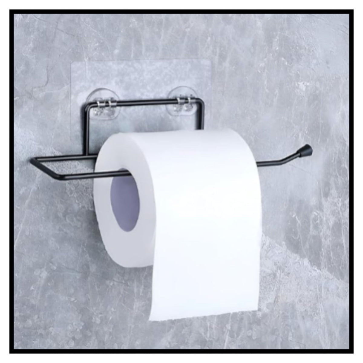 Black metal toilet paper holder with two clear suction cups mounted on gray textured wall holding a roll of white toilet paper